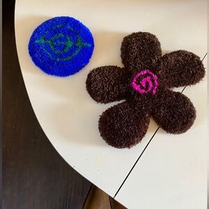 Two coasters made of rug fabric